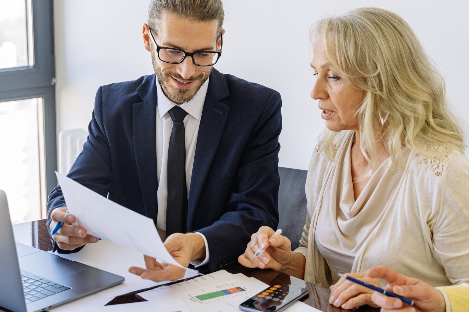 Financial advisor reviewing documents with a client
